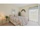 Bright bedroom with floral accents, large window, and comfortable furniture at 7304 W Country Club N Dr # 113, Sarasota, FL 34243