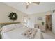 Bedroom with view to adjacent bathroom, desk, and outdoor scenery at 7304 W Country Club N Dr # 113, Sarasota, FL 34243