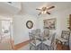 Inviting dining area with a glass table, seating for four, and an adjacent bedroom and kitchen view at 7304 W Country Club N Dr # 113, Sarasota, FL 34243