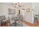 Bright dining area featuring a glass table with seating for four, and an adjacent kitchen view at 7304 W Country Club N Dr # 113, Sarasota, FL 34243
