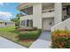 Inviting condo featuring mature landscaping, a screened porch, and a private entrance at 7304 W Country Club N Dr # 113, Sarasota, FL 34243
