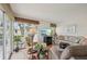 Relaxing living room with hardwood floors, sunroom access, comfortable seating, and a flatscreen TV at 7304 W Country Club N Dr # 113, Sarasota, FL 34243