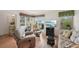 Cozy living room with hardwood floors, a large window view, comfortable seating, and a flatscreen TV at 7304 W Country Club N Dr # 113, Sarasota, FL 34243