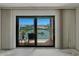 Balcony featuring waterfront views, black railings, a small table with lamp, and dark tile flooring at 7600 Sun Island S Dr # 603, South Pasadena, FL 33707
