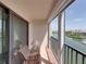 A tiled balcony with a chair and a view of the harbor is a nice place to sit and relax at 7600 Sun Island S Dr # 603, South Pasadena, FL 33707