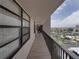 Outdoor corridor overlooking the swimming pool, the tennis courts, and parking area at 7600 Sun Island S Dr # 603, South Pasadena, FL 33707