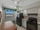 Kitchen with black appliances, white cabinetry, and an eat-in nook with scenic views at 7600 Sun Island S Dr # 603, South Pasadena, FL 33707