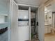 A laundry closet with a stackable washer/dryer and water heater is located near the bathroom at 7600 Sun Island S Dr # 603, South Pasadena, FL 33707