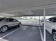 Assigned covered parking space with view of the waterfront area with palm trees at 7600 Sun Island S Dr # 603, South Pasadena, FL 33707