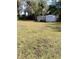 Spacious backyard featuring two storage sheds and lush green grass at 7608 Chenkin, Zephyrhills, FL 33540