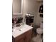 Bathroom featuring a single sink vanity, toilet, and storage shelves for toiletries at 7608 Chenkin, Zephyrhills, FL 33540