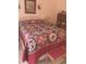Bedroom featuring a bed with a colorful quilt, artwork, and a cozy atmosphere at 7608 Chenkin, Zephyrhills, FL 33540
