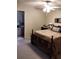 Spacious bedroom featuring a ceiling fan and adjacent bathroom with a sink at 7608 Chenkin, Zephyrhills, FL 33540