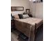 Spacious bedroom with neutral decor, wooden furniture, and a cozy quilt at 7608 Chenkin, Zephyrhills, FL 33540