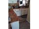 Kitchen featuring custom wood countertops, white cabinets and stainless sink at 7608 Chenkin, Zephyrhills, FL 33540