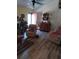 Cozy living room with vaulted ceilings, luxury vinyl flooring, a ceiling fan, and lots of natural light at 7608 Chenkin, Zephyrhills, FL 33540