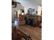 The living room features a stone fireplace, wood mantel and hardwood floors at 7608 Chenkin, Zephyrhills, FL 33540