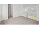 Upstairs bedroom featuring neutral carpet, white walls and trim, and a window offering natural light at 8316 Golden Beach Ct, Parrish, FL 34219