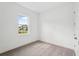 Bedroom with neutral carpet, window, baseboard, and a door, offering a simple and bright living space at 8316 Golden Beach Ct, Parrish, FL 34219