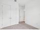 Bedroom with neutral carpet and a closet with a large double door that maximizes space and style at 8316 Golden Beach Ct, Parrish, FL 34219