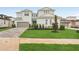 Charming two-story home with a well-manicured lawn and a brick driveway leading to a two-car garage at 8316 Golden Beach Ct, Parrish, FL 34219