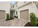 Beautiful home entrance with stone paver driveway leading to the front door and two-car garage at 8316 Golden Beach Ct, Parrish, FL 34219