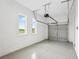 Spacious two car garage featuring a modern epoxy floor, windows and an automatic door at 8316 Golden Beach Ct, Parrish, FL 34219