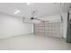 Spacious garage with epoxy flooring and automatic door, offering secure parking and storage at 8316 Golden Beach Ct, Parrish, FL 34219