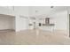 Spacious great room with sleek wood floors, white walls, high ceilings, and a modern kitchen at 8316 Golden Beach Ct, Parrish, FL 34219