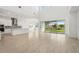 Open-concept living area with light wood floors, high ceilings, and large sliding glass doors to backyard at 8316 Golden Beach Ct, Parrish, FL 34219