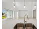 Modern kitchen featuring stainless steel sink, stylish faucet, and quartz countertops that provide a sleek and modern aesthetic at 8316 Golden Beach Ct, Parrish, FL 34219