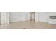 Bright and airy living room with wood floors and white walls and view into adjoinging space at 8316 Golden Beach Ct, Parrish, FL 34219