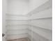 Spacious walk-in pantry with ample wire shelving for organized storage at 8316 Golden Beach Ct, Parrish, FL 34219