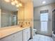 Well-lit bathroom with single vanity, toilet, and glass-enclosed shower at 8822 Misty Creek Dr, Sarasota, FL 34241