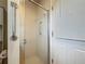 Bathroom features a frosted glass shower door with a chrome grab bar, ensuring both style and accessibility at 8822 Misty Creek Dr, Sarasota, FL 34241