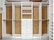 Large walk-in closet with custom shelving and storage solutions for organization at 8822 Misty Creek Dr, Sarasota, FL 34241