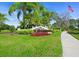Welcome to Misty Creek, featuring a beautifully landscaped entrance with vibrant flowers and lush greenery at 8822 Misty Creek Dr, Sarasota, FL 34241