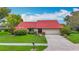 Charming single-story home with well-manicured lawn and a red tiled roof, perfect for curb appeal at 8822 Misty Creek Dr, Sarasota, FL 34241