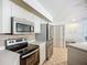 Kitchen boasts stainless steel appliances, ample cabinet space, and a built-in desk area for added convenience at 8822 Misty Creek Dr, Sarasota, FL 34241