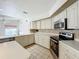 Bright kitchen featuring modern stainless steel appliances, light countertops, and a complementary tile backsplash at 8822 Misty Creek Dr, Sarasota, FL 34241