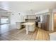 Modern kitchen with stainless steel appliances, white cabinets, and a center island for meal prep at 8822 Misty Creek Dr, Sarasota, FL 34241