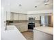 The kitchen features white cabinets, stainless steel appliances, a central island, and a sleek, modern design at 8822 Misty Creek Dr, Sarasota, FL 34241