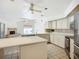 Bright kitchen with white cabinetry, stainless appliances, tile backsplash, and a central island for food preparation at 8822 Misty Creek Dr, Sarasota, FL 34241