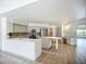 Spacious open-concept kitchen features modern appliances and an adjoining dining area with a built in desk at 8822 Misty Creek Dr, Sarasota, FL 34241
