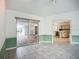 Living room with sliding glass door accessing patio and a peek into the adjacent modern kitchen at 8822 Misty Creek Dr, Sarasota, FL 34241