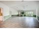 Open living space featuring tile floors, neutral decor, and easy access to the kitchen and entry at 8822 Misty Creek Dr, Sarasota, FL 34241