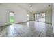 Spacious living room with tile floors and sliding glass doors leading to a screened-in pool area at 8822 Misty Creek Dr, Sarasota, FL 34241