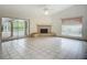 Open living room boasts a fireplace, tile flooring, and seamless access to an outdoor pool area, perfect for relaxation at 8822 Misty Creek Dr, Sarasota, FL 34241