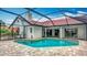 Beautiful pool area with screened enclosure, seamlessly blending indoor and outdoor living with lush landscaping at 8822 Misty Creek Dr, Sarasota, FL 34241