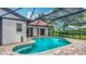 Beautiful pool area with screened enclosure, seamlessly blending indoor and outdoor living with lush landscaping at 8822 Misty Creek Dr, Sarasota, FL 34241